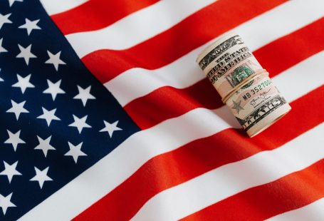 american-flag-with-rolled-dollar-bills